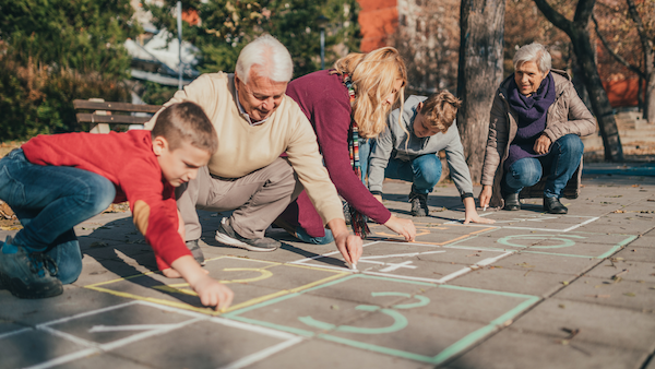 Multigenerational family playing hopscotch game together