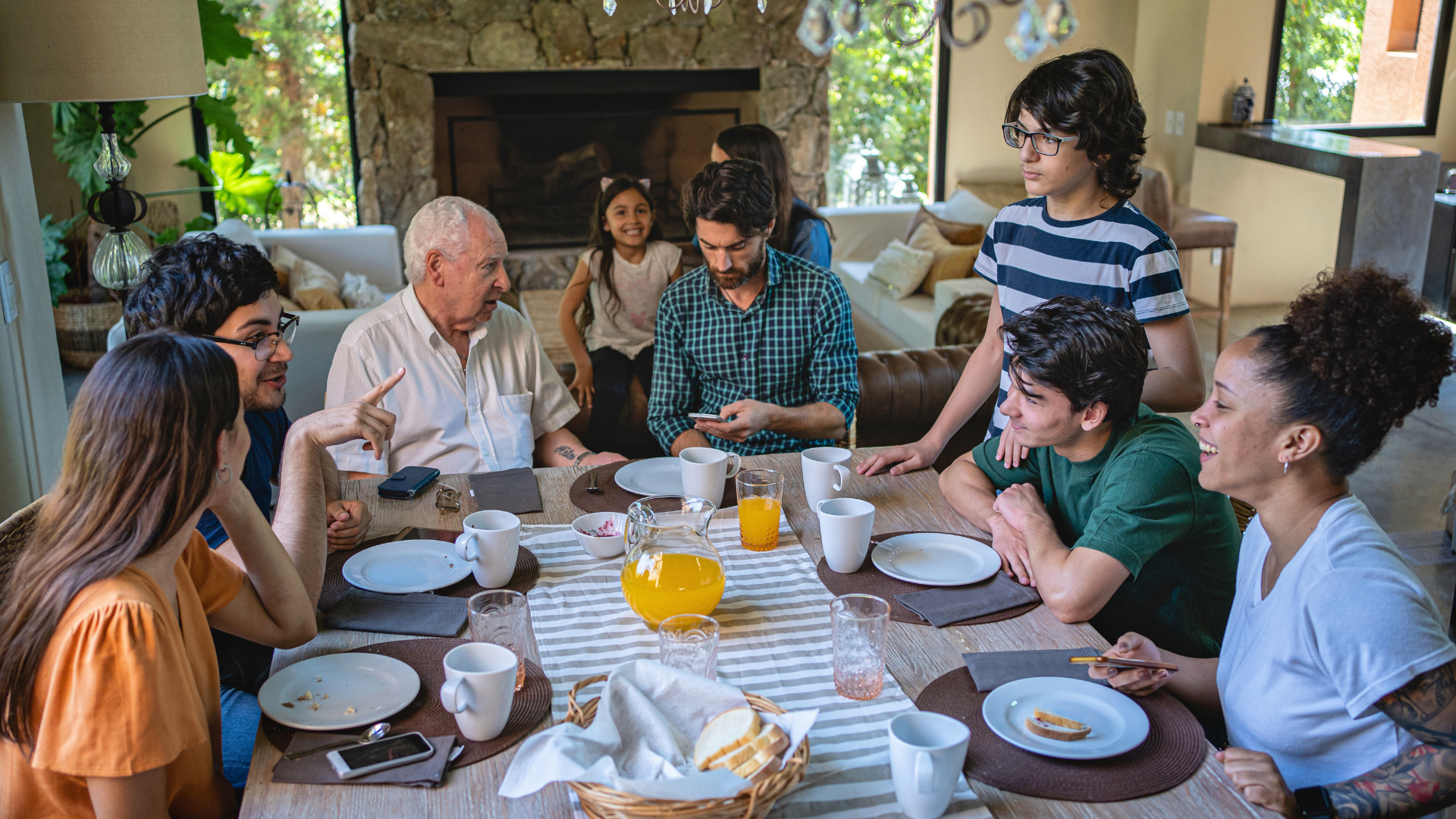 Multigenerational family sitting around dining table having dinner