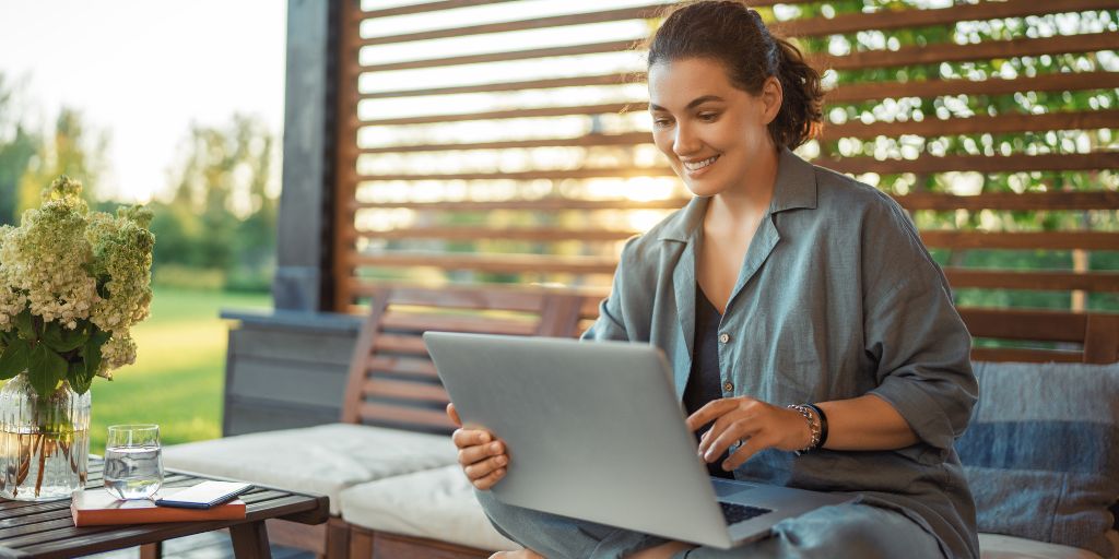 woman working on computer on patio