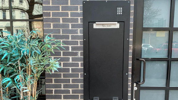 Box gobbler mounted in outdoor brick wall