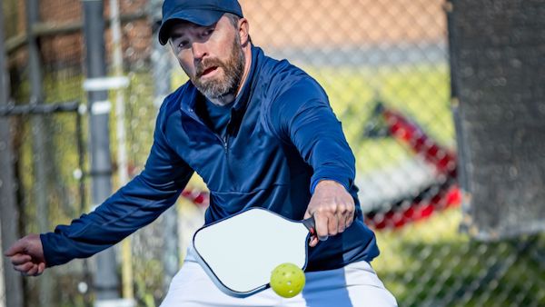 Bearded man play pickleball