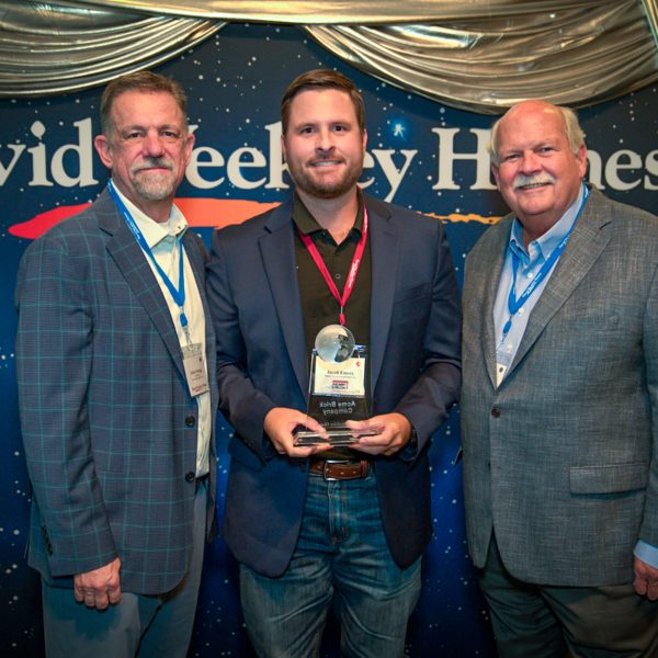 Acme Brick's Jacob Emery accepts the Partners of Choice Award from David Weekley Homes
