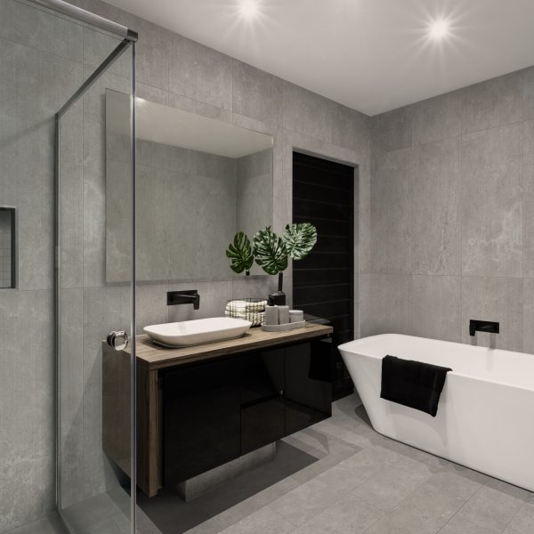 Modern bathroom with a shower area and bath tub including a wall mirror beside a fancy plant near a tap and sink over the wooden counter and dark cupboard
