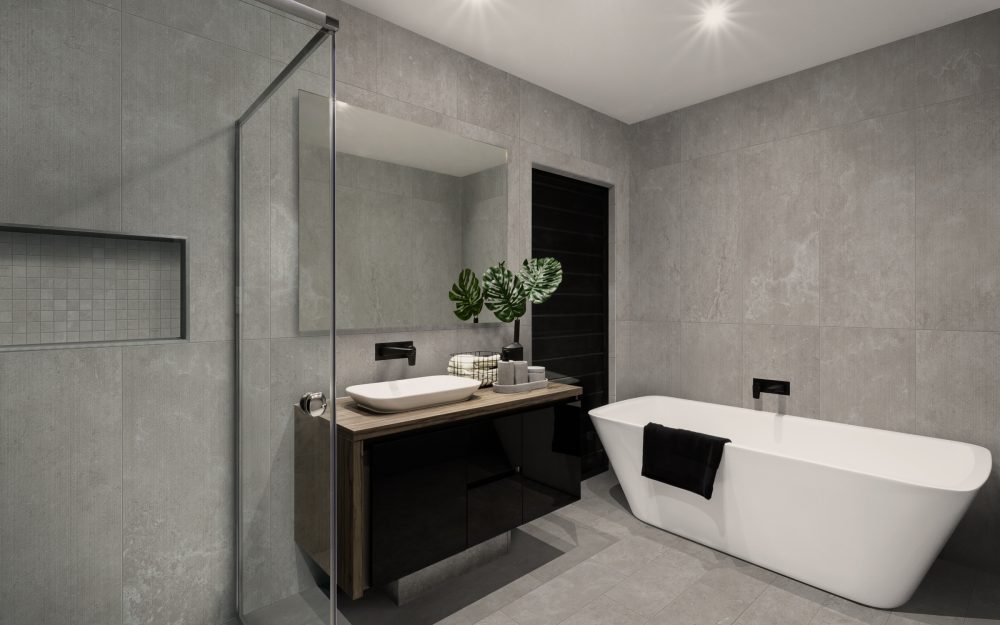 Modern bathroom with a shower area and bath tub including a wall mirror beside a fancy plant near a tap and sink over the wooden counter and dark cupboard