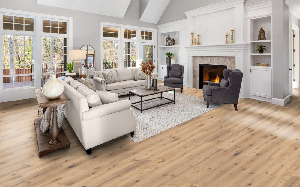 Beautiful living room in new traditional style luxury home. Features vaulted ceilings, fireplace with roaring fire, and elegant furnishings.